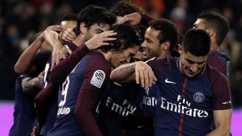 PSG players celebrate after PSG's Javier Pastore, obscured, scored a goal during their French League One soccer match between Paris-Saint-Germain and Nantes, at the Parc des Princes stadium in Paris, France, Saturday, Nov.18, 2017. (AP Photo/Thibault Camus)