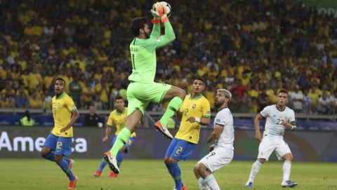 Brazil's goalkeeper Alisson jumps to catch the ball during a Copa America semifinal soccer match against Argentina at the Mineirao stadium in Belo Horizonte, Brazil, Tuesday, July 2, 2019. (AP Photo/Ricardo Mazalan)