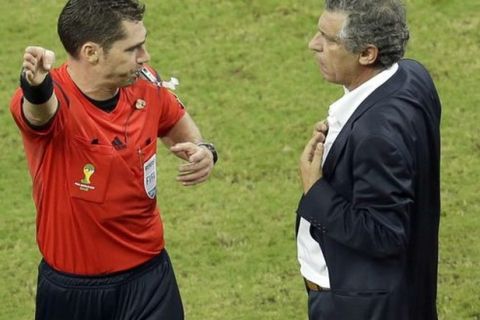 Referee Benjamin Williams from Australia sends Greece's head coach Fernando Santos off the field during the World Cup round of 16 soccer match between Costa Rica and Greece at the Arena Pernambuco in Recife, Brazil, Sunday, June 29, 2014. (AP Photo/Hassan Ammar)