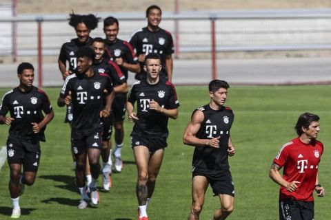 Robert Lewandowski, center, exercise with his team during a training session of Bayern Munich in Munich, Germany, Thursday, July 23, 2020. Bayern will play Chelsea in the Round of 16 second leg Champions League soccer match on Aug. 8 in Munich. (AP Photo/Matthias Schrader)