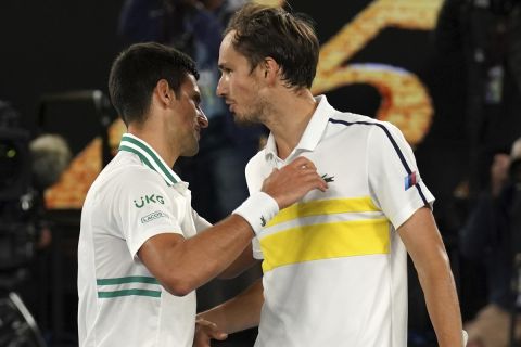 Serbia's Novak Djokovic, left, is congratulated by Russia's Daniil Medvedev after winning the men's singles final at the Australian Open tennis championship in Melbourne, Australia, Sunday, Feb. 21, 2021.(AP Photo/Mark Dadswell)