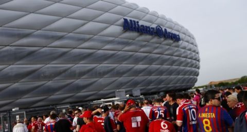 Soccer fans arrive for the soccer Champions League second leg semifinal match between Bayern Munich and FC Barcelona at Allianz Arena in Munich, southern Germany, Tuesday, May 12, 2015. (AP Photo/Matthias Schrader)