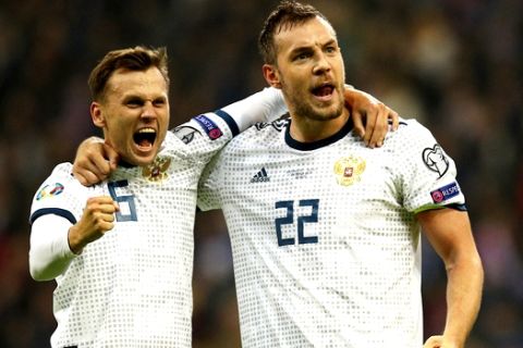 Russia's Artem Dzyuba, right, and Denis Cheryshev celebrates after scoring their side's 3rd goal during the Euro 2020 group I qualifying soccer match between Kazakhstan and Russia at the Astana Arena stadium in Nur-Sultan, Kazakhstan, Sunday, March 24, 2019. (AP Photo)