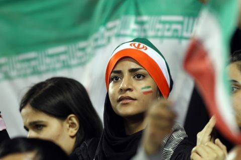 Iranian young woman fans watch their team winning during their 2014 World Cup Asian zone qualifying football match between Qatar and Iran at the Al-Sadd stadium in Doha on, Tuesday,June, 4, 2013. (AP Photo/Osama Faisal)