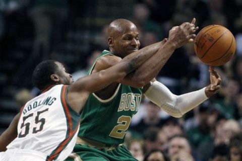 Boston Celtics' Ray Allen, right, and Milwaukee Bucks' Keyon Dooling (55) battle for a loose ball in the third quarter of an NBA basketball game, Sunday, March 13, 2011, in Boston. The Celtics won 87-56. (AP Photo/Michael Dwyer)