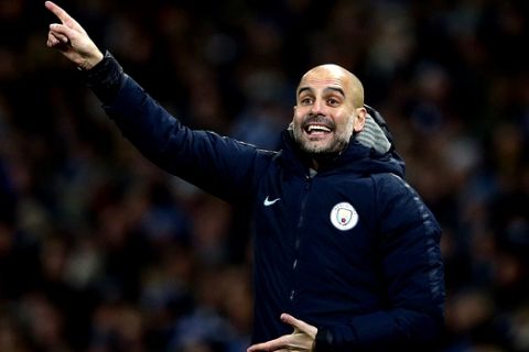 Manchester City's coach Pep Guardiola gestures during the English Premier League soccer match between Manchester City and Liverpool at the Etihad Stadium in Manchester, England, Thursday, Jan. 3, 2019.(AP Photo/Dave Thompson)