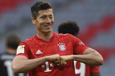 Bayern Munich's Polish forward Robert Lewandowski reacts after scoring his 4-0 during the German Bundesliga soccer match between FC Bayern Munich and Fortuna Duesseldorf in Munich, Germany, Saturday, May 30, 2020. Because of the coronavirus outbreak all soccer matches of the German Bundesliga take place without spectators. (Christof Stache/Pool via AP)