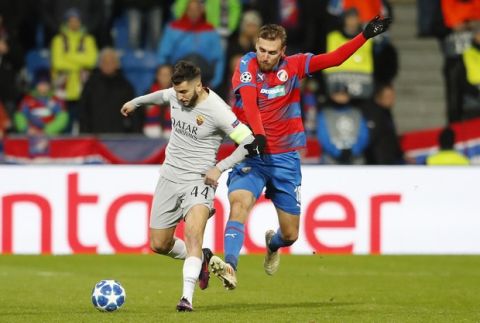 Roma's Kostas Manolas, left, challenges for the ball with Plzen's Tomas Chory during the Champions League group G soccer match between Viktoria Plzen and Roma at the Doosan arena in Pilsen, Czech Republic, Wednesday, Dec. 12, 2018. (AP Photo/Petr David Josek)