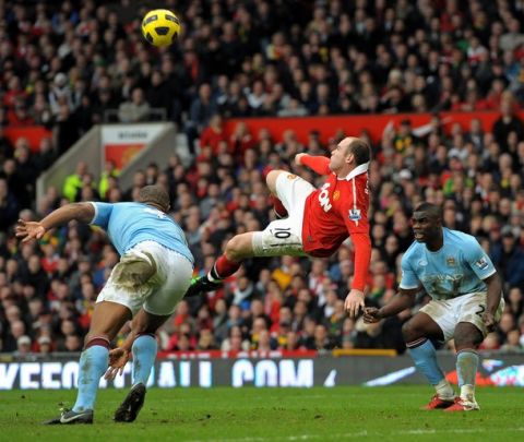 Manchester United's English striker Wayne Rooney (2nd L) scores their second goal between Manchester City's Belgian midfielder Vincent Kompany (L) and English defender Micah Richards (R) during the English Premier League football match between Manchester United and Manchester City at Old Trafford in Manchester, north-west England on February 12, 2011. AFP PHOTO/ANDREW YATESRESTRICTED TO EDITORIAL USE Additional licence required for any commercial/promotional use or use on TV or internet (except identical online version of newspaper) of Premier League/Football League photos. Tel DataCo +44 207 2981656. Do not alter/modify photo (Photo credit should read ANDREW YATES/AFP/Getty Images)