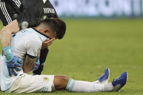 Argentina's Leandro Paredes is comforted by goalkeeper Franco Armani after losing 2-0 to Brazil at the end of their Copa America semifinal soccer match at Mineirao stadium in Belo Horizonte, Brazil, Tuesday, July 2, 2019. Argentina was eliminated from tournament and Brazil advanced to the final. (AP Photo/Ricardo Mazalan)