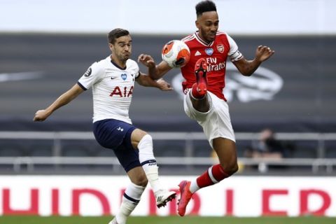 Tottenham's Harry Winks vies for the ball with Arsenal's Pierre-Emerick Aubameyang, right, during the English Premier League soccer match between Tottenham Hotspur and Arsenal at the Tottenham Hotspur Stadium in London, England, Sunday, July 12, 2020. (Tim Goode/Pool via AP)