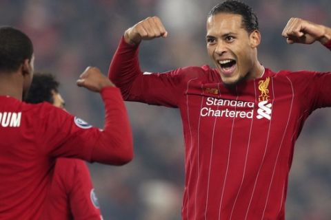 Liverpool's Georginio Wijnaldum, left, celebrates with Virgil van Dijk after scoring the opening goal during the Champions League group E soccer match between Liverpool and Genk at Anfield Stadium, Liverpool, England, Tuesday, Nov. 5, 2019. (AP Photo/Jon Super)