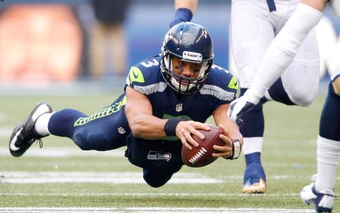 SEATTLE, WA - DECEMBER 30:  Russell Wilson #3 of the Seattle Seahawks dives for extra yardage against the St. Louis Rams in the first half at CenturyLink Field on December 30, 2012 in Seattle, Washington.  (Photo by Kevin Casey/Getty Images)