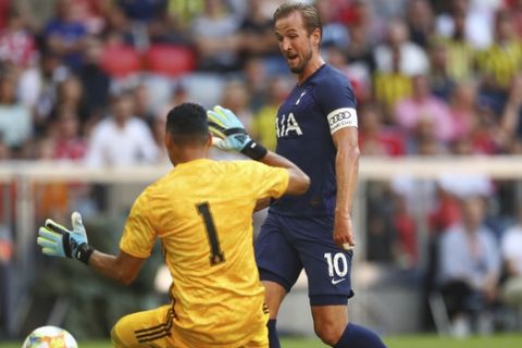Tottenham forward Harry Kane scores his side's opening goal against Real goalkeeper Keylor Navas during the friendly soccer Audi Cup match between Tottenham Hotspur and Real Madrid at the Allianz Arena stadium in Munich, Germany, Tuesday, July 30, 2019. (AP Photo/Matthias Schrader)