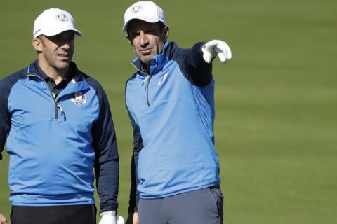 Soccer legends Luis Figo, left, and Alessandro Del Piero, playing for Europe, speak on the 2nd fairway during the Ryder Cup Celebrity Challenge match at Le Golf National in Saint-Quentin-en-Yvelines, outside Paris, France, Tuesday, Sept. 25, 2018. The 42nd Ryder Cup will be held in France from Sept. 28-30, 2018 at Le Golf National. (AP Photo/Matt Dunham)