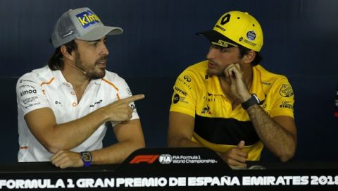 McLaren's Fernando Alonso of Spain, left, gestures next to Renault's Carlos Sainz of Spain during a press conference at the Barcelona Catalunya racetrack in Montmelo, just outside Barcelona, Spain, Thursday, May 10, 2018. The Formula One race will be held on Sunday. (AP Photo/Manu Fernandez)