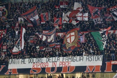 AC Milan fans display a banner reading "United in the sorrow of Astori's family, Rest in Peace" during the Europa League, round of 16 first-leg soccer match between AC Milan and Arsenal, at the Milan San Siro stadium, Italy, Thursday, March 8, 2018. (AP Photo/Antonio Calanni)
