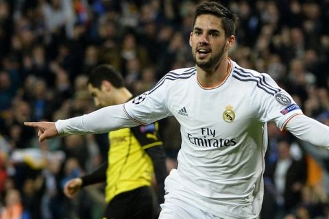 Real Madrid's midfielder Isco (C) celebrates after scoring during the UEFA Champions League quarterfinal first leg football match Real Madrid FC vs Borussia Dortmund at the Santiago Bernabeu stadium in Madrid on April 2, 2014.   AFP PHOTO/ GERARD JULIEN        (Photo credit should read GERARD JULIEN/AFP/Getty Images)