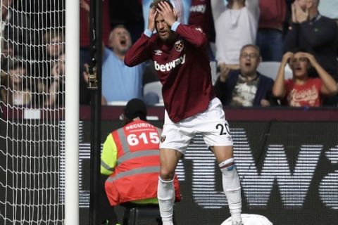 West Ham's Andriy Yarmolenko reacts after missing a chance to score during the English Premier League soccer match between West Ham United and Chelsea at London Stadium in London, Sunday, Sept. 23, 2018. (AP Photo/Matt Dunham)