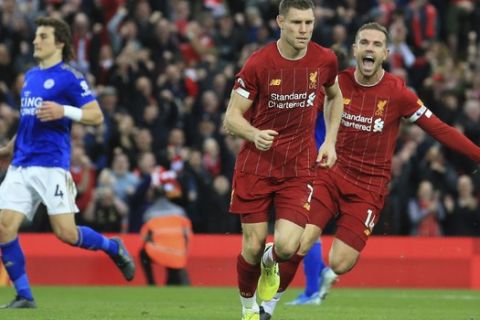 Liverpool's James Milner celebrates his wining goal with Liverpool's Jordan Henderson during English Premier League soccer match between Liverpool and Leicester City in Anfield stadium in Liverpool, England, Saturday, Oct. 5, 2019. (AP Photo/Jon Super)