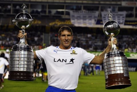 Former Boca Juniors footballer Martin Palermo holds Boca Juniors' two Copa Libertadores trophies, before the start of his farewell football match, at La Bombonera stadium in Buenos Aires, on February 4, 2012. AFP PHOTO / Alejandro PAGNI (Photo credit should read ALEJANDRO PAGNI/AFP/Getty Images)