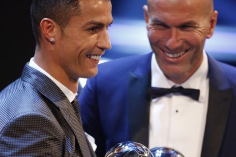 Portuguese soccer player Christiano Ronaldo holds the Best FIFA Men's player award and Soccer coach Zinedine Zidane holds the Best FIFA Men's Coach award during The Best FIFA 2017 Awards at the Palladium Theatre in London, Monday, Oct. 23, 2017. (AP Photo/Alastair Grant)