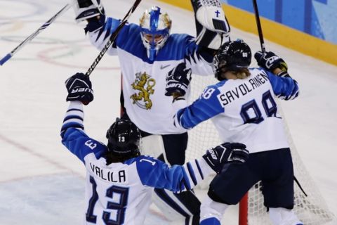 Foalie Noora Raty, of Finland, celebrates with teammates Ronja Savolainen, right, and Riikka Valila, left, after the women's bronze medal hockey game at the 2018 Winter Olympics in Gangneung, South Korea, Wednesday, Feb. 21, 2018. Finland won 3-2. (AP Photo/Frank Franklin II)