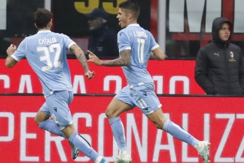 Lazio's Joaquin Correa, right, celebrates after scoring his side's second goal during the Serie A soccer match between AC Milan and Lazio at the San Siro stadium, in Milan, Italy, Sunday, Nov. 3, 2019, (AP Photo/Antonio Calanni)