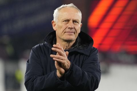 Freiburg's head coach Christian Streich applauds to fans after the Europa League Group A soccer match between West Ham United and SC Freiburg at the London stadium in London, Thursday, Dec. 14, 2023. (AP Photo/Kirsty Wigglesworth)