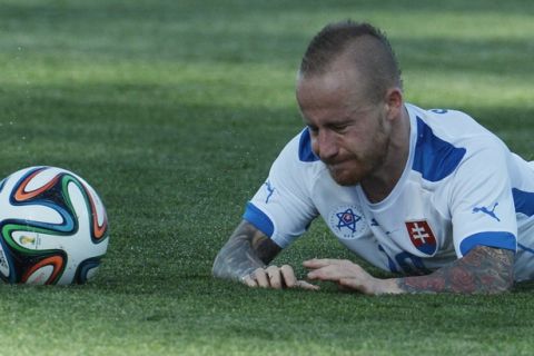 Slovakia's Miroslav Stoch falls down during a friendly soccer match between Russia and Slovakia in St. Petersburg, Russia, Monday, May 26, 2014. Russia won 1-0. (AP Photo)