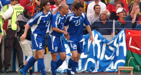 Greece's Georgios Karagounis celebrates scoring the opening goal with teammates Georgios Seitaridis (l) and Stylianos Giannakopoulos (c)