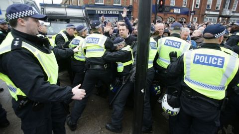 Soccer fans push against police prior to the Tottenham Hotspur v Millwall, English FA Cup quarter final game at White Hart Lane, Tottenham, London Sunday March 12, 2017. (Yui Mok//PA via AP)