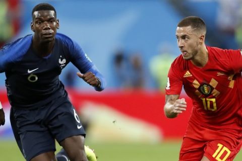 France's Paul Pogba, left, challenges for the ball with Belgium's Eden Hazard during the semifinal match between France and Belgium at the 2018 soccer World Cup in the St. Petersburg Stadium, in St. Petersburg, Russia, Tuesday, July 10, 2018. (AP Photo/David Vincent)