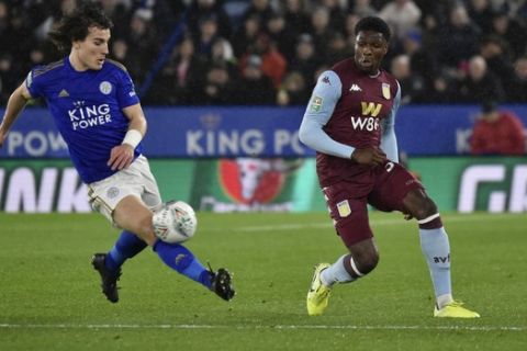 Aston Villa's Caglar Soyuncu, left, is challenged by Leicester's Kortney Hause during the English League Cup semifinal first leg soccer match between Leicester City and Aston Villa at the King Power Stadium in Leicester, England, Wednesday, Jan. 8, 2020. (AP Photo/Rui Vieira)