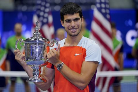 Carlos Alcaraz, of Spain, holds up the championship trophy after defeating Casper Ruud, of Norway, in the men's singles final of the U.S. Open tennis championships, Sunday, Sept. 11, 2022, in New York. (AP Photo/Charles Krupa)