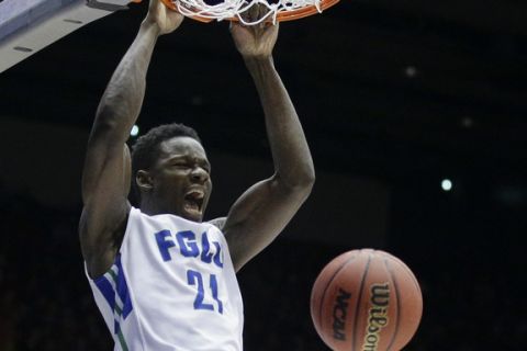 Florida Gulf Coast's Demetris Morant (21) dunks as Fairleigh Dickinson's Earl Potts Jr. (5) reacts in the first half of a First Four game of the NCAA college basketball tournament, Tuesday, March 15, 2016, in Dayton, Ohio. (AP Photo/John Minchillo)