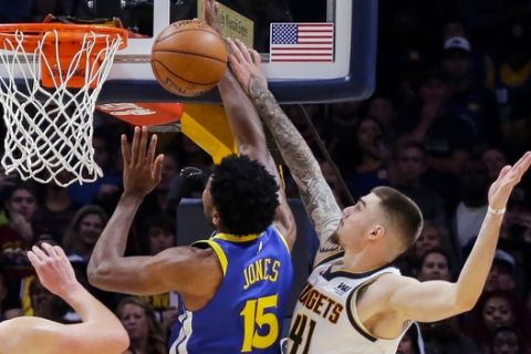 Denver Nuggets forward Juancho Hernangomez (41) blocks a shot by Golden State Warriors center Damian Jones (15) in the final seconds during the fourth quarter of an NBA basketball game, Sunday, Oct. 21, 2018, in Denver. The Nuggets beat the Warriors 100-98. (AP Photo/Jack Dempsey)