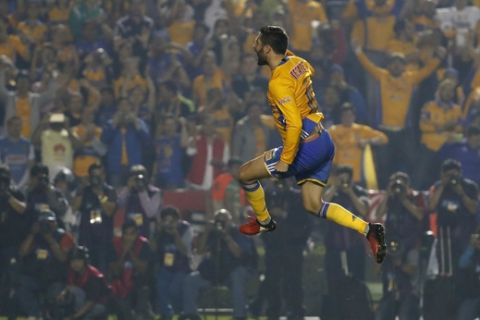 In this Sunday, Dec. 25, 2016 photo, Tigres' Andre Pierre Gignac celebrates after scoring during a penalty shootout against America during the Mexican soccer league final match in Monterrey, Mexico. Tigres won the Apertura 2016 Final on penalty kicks. (AP Photo/Eduardo Verdugo)