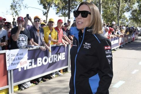 Claire Williams, the deputy team principal of the Williams team, keeps her distance from fans as she arrives at the Australian Formula One Grand Prix in Melbourne, Thursday, March 12, 2020. (AP Photo/Andy Brownbill)