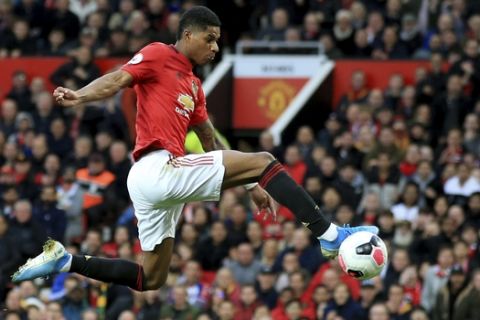 Manchester United's Marcus Rashford kicks the ball during the English Premier League soccer match between Manchester United and Liverpool at the Old Trafford stadium in Manchester, England, Sunday, Oct. 20, 2019. (AP Photo/Jon Super)