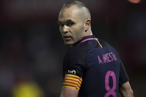 FILE - In this Sunday April 2, 2017 file photo, FC Barcelona's Andres Iniesta gestures during their Spanish La Liga soccer match against Granada in Granada, Spain. Barcelona has Neymar back from suspension but captain Andres Iniesta is in doubt for the local derby against Espanyol this weekend in the Spanish league. Iniesta is bothered by a right leg muscle injury and did not practice on Friday, April 28. (AP Photo/Daniel Tejedor, file)