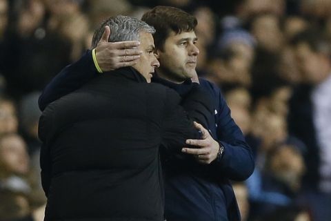 Tottenham manager Mauricio Pochettino, right, embraces Chelsea manager Jose Mourinho at the end of the English Premier League soccer match between Tottenham Hotspur and Chelsea at White Hart Lane Stadium in London, Thursday, Jan. 1, 2015. (AP Photo/Kirsty Wigglesworth)