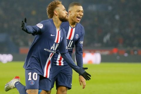 PSG's Neymar, left, celebrates with PSG's Kylian Mbappe after scoring his side's opening goal during the French League One soccer match between PSG and Nantes at the Parc des Princes stadium in Paris, Wednesday, Dec. 4, 2019. The goal was disallowed on a VAR (video assistant referee) decision. (AP Photo/Michel Euler)