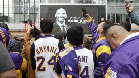People gather outside Staples Center after the death of Laker legend Kobe Bryant, Sunday, Jan. 26, 2020, in Los Angeles. (AP Photo/Michael Owen Baker)