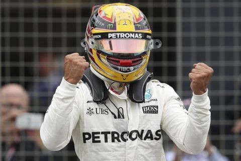Mercedes driver Lewis Hamilton of Britain celebrates after he clocked the fastest time during the qualifying session for the British Formula One Grand Prix at the Silverstone racetrack in Silverstone, England, Saturday, July 15, 2017. The British Formula One Grand Prix will be held on Sunday, July 16. (David Davies/PA via AP)