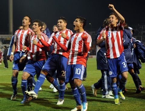 Paraguayan footballers celebrate at the end of thei 2011 Copa America semi-final match agaisnt Venezuela, at the Malvinas Argentinas stadium in Mendoza, 1058 Km west of Buenos Aires, on July 20, 2011. Paraguay won 5-3 in penalty shoot-out and qualified for the final.    AFP PHOTO / RODRIGO ARANGUA (Photo credit should read RODRIGO ARANGUA/AFP/Getty Images) ORG XMIT: