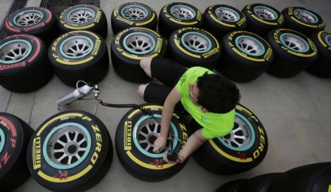 FILE - In this Wednesday, March 30, 2016 photo, a Mercedes mechanic prepares tires ahead of this weekend's Formula 1 Grand Prix at the Bahrain International Circuit, , in Sakhir, Bahrain. The night race will be held April 3. (AP Photo/Hasan Jamali, File)