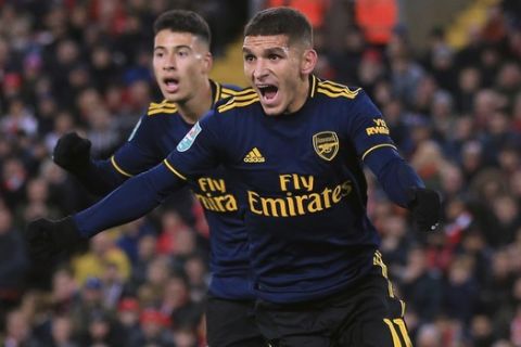 Arsenal's Lucas Torreira, right, celebrates after scoring his side's opening goal during the English League Cup soccer match between Liverpool and Arsenal at Anfield stadium in Liverpool, England, Wednesday, Oct. 30, 2019. (AP Photo/Jon Super)
