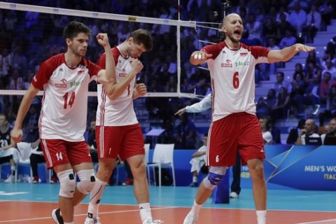 Poland's Bartosz Kurek, right, celebrates winning a point during the Men's World Championships volleyball semifinal match between The United States and Poland, in Turin, Italy, Saturday, Sept. 29, 2018. (AP Photo/Luca Bruno)