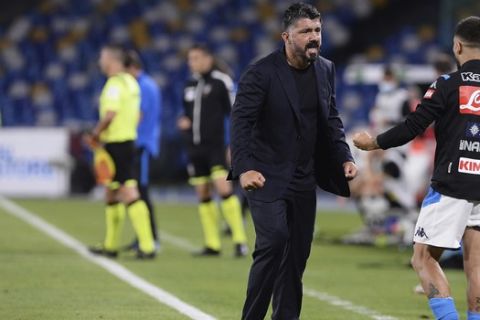 Napoli's head coach Gennaro Gattuso, second from right, celebrates with his player Lorenzo Insigne after an Italian Cup second leg semifinal soccer match between Napoli and Inter Milan, at the Naples San Paolo Stadium in Naples, Italy, Saturday, June 13, 2020. The match was played without spectators because of the COVID-19 restriction measures. (Cafaro/LaPresse via AP)
